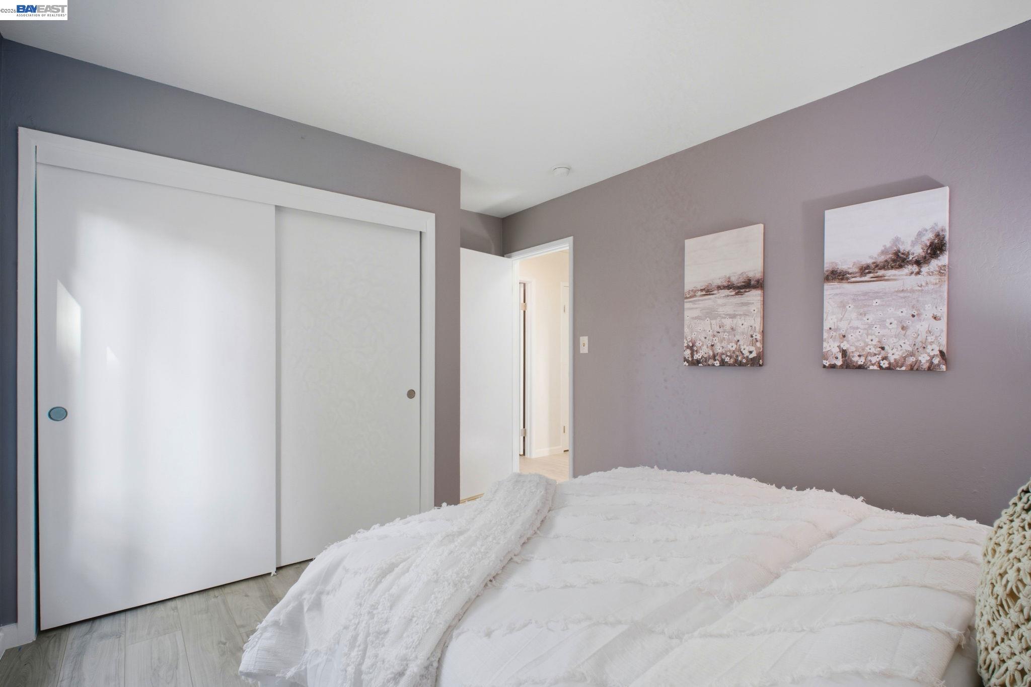 4987 Winchester Place Newark, CA 94560 - Photo 14 of 25 a bedroom with a bed and wall painting