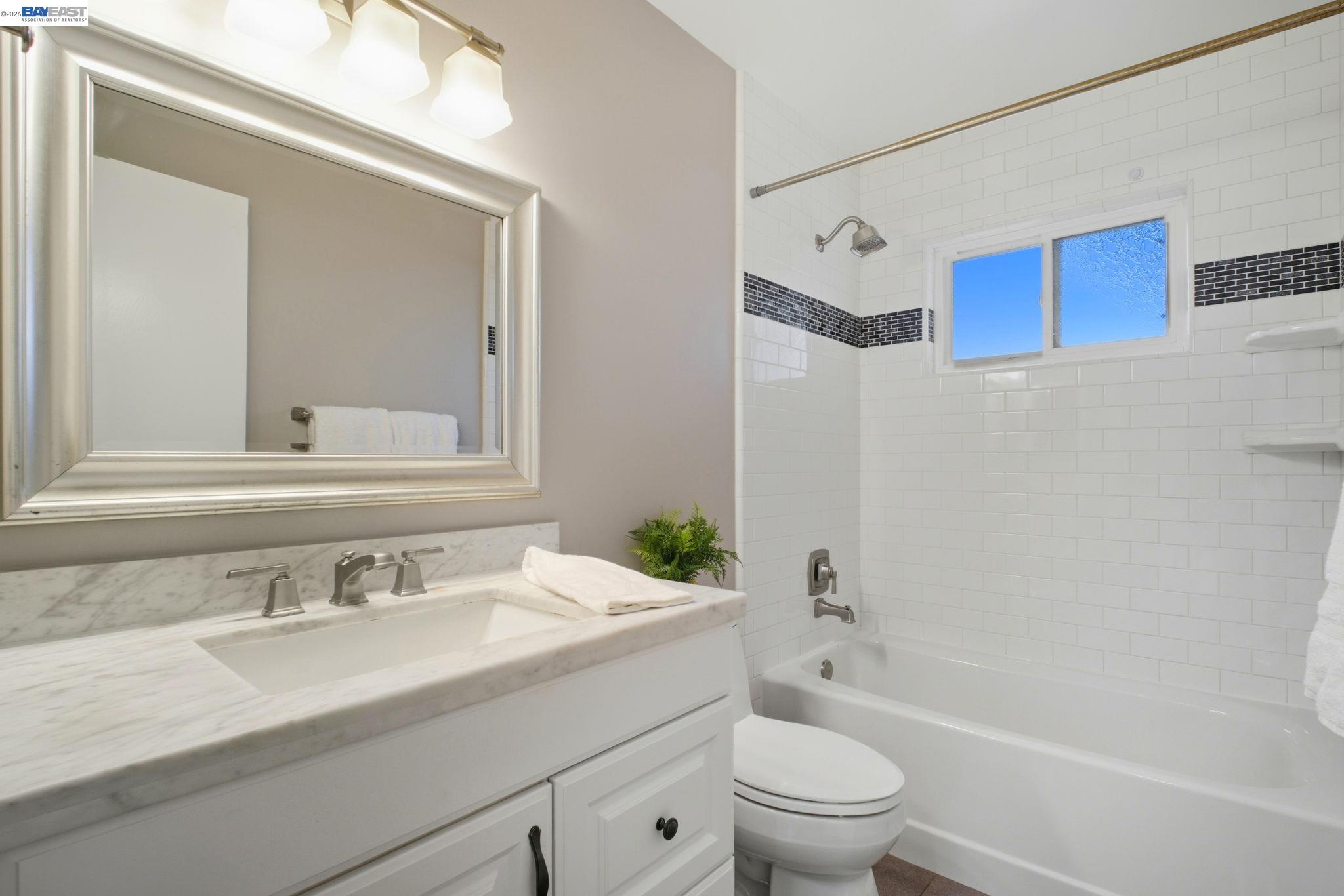 4987 Winchester Place Newark, CA 94560 - Photo 16 of 25 a bathroom with a granite countertop sink a toilet and a mirror