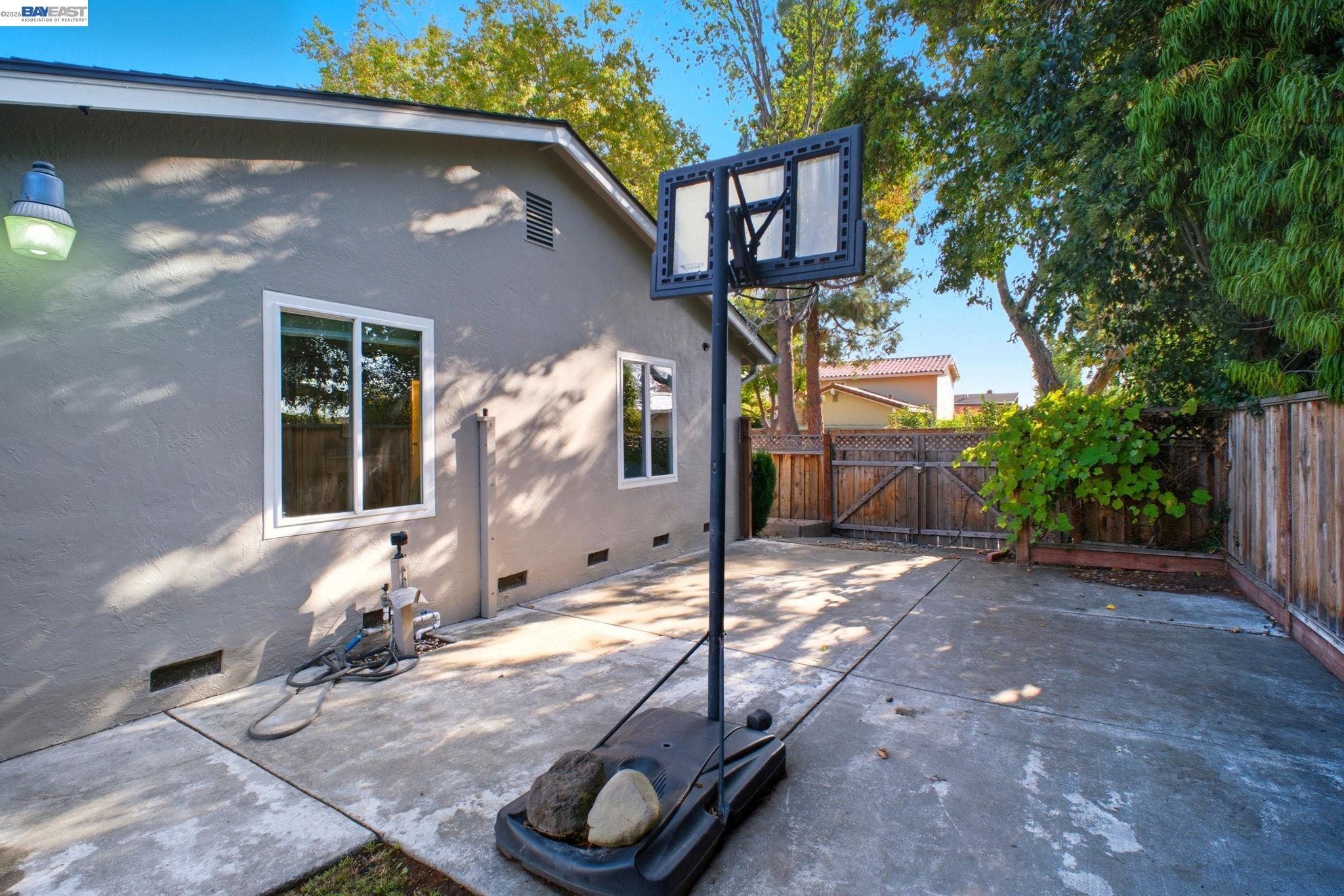 4987 Winchester Place Newark, CA 94560 - Photo 22 of 25 a backyard of a house with table and chairs