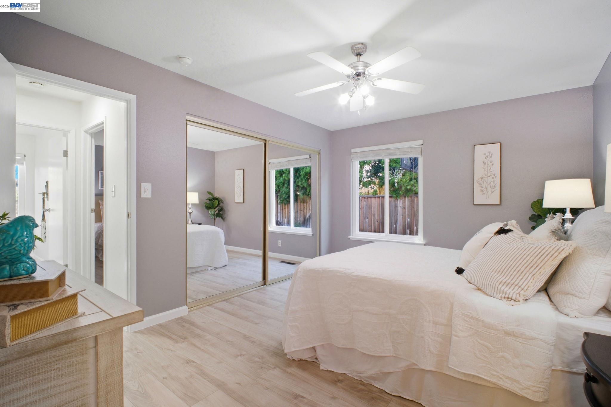 4987 Winchester Place Newark, CA 94560 - Photo 10 of 25 a bedroom with a large bed and chandelier