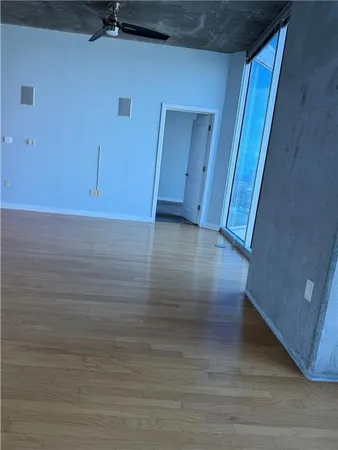 a view of an empty room with a fireplace and a large window