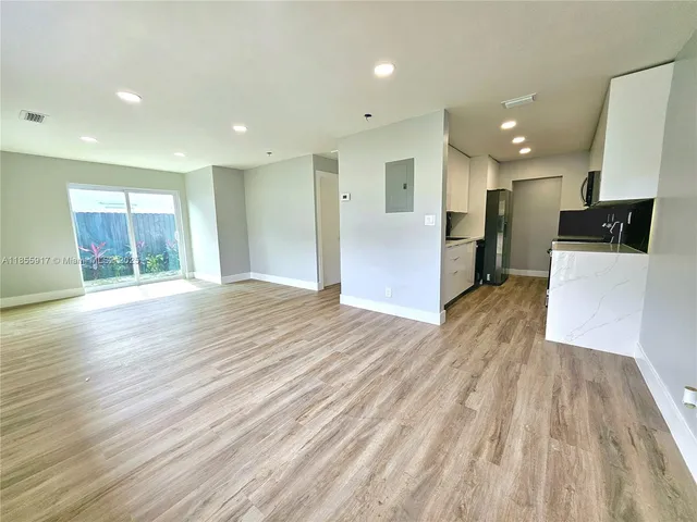 a view of a kitchen with wooden floor and a sink