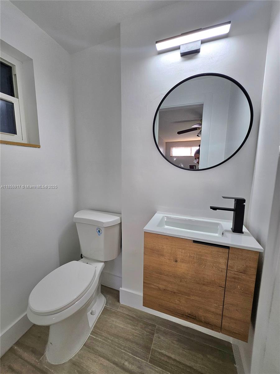 2865 Northeast 13th Avenue Pompano Beach, FL 33064 - Photo 11 of 19 a bathroom with a toilet a sink and mirror