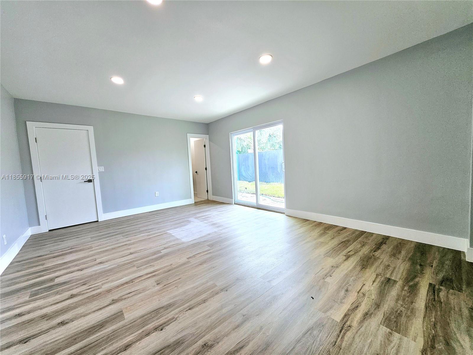 2865 Northeast 13th Avenue Pompano Beach, FL 33064 - Photo 12 of 19 wooden floor in an empty room with a window