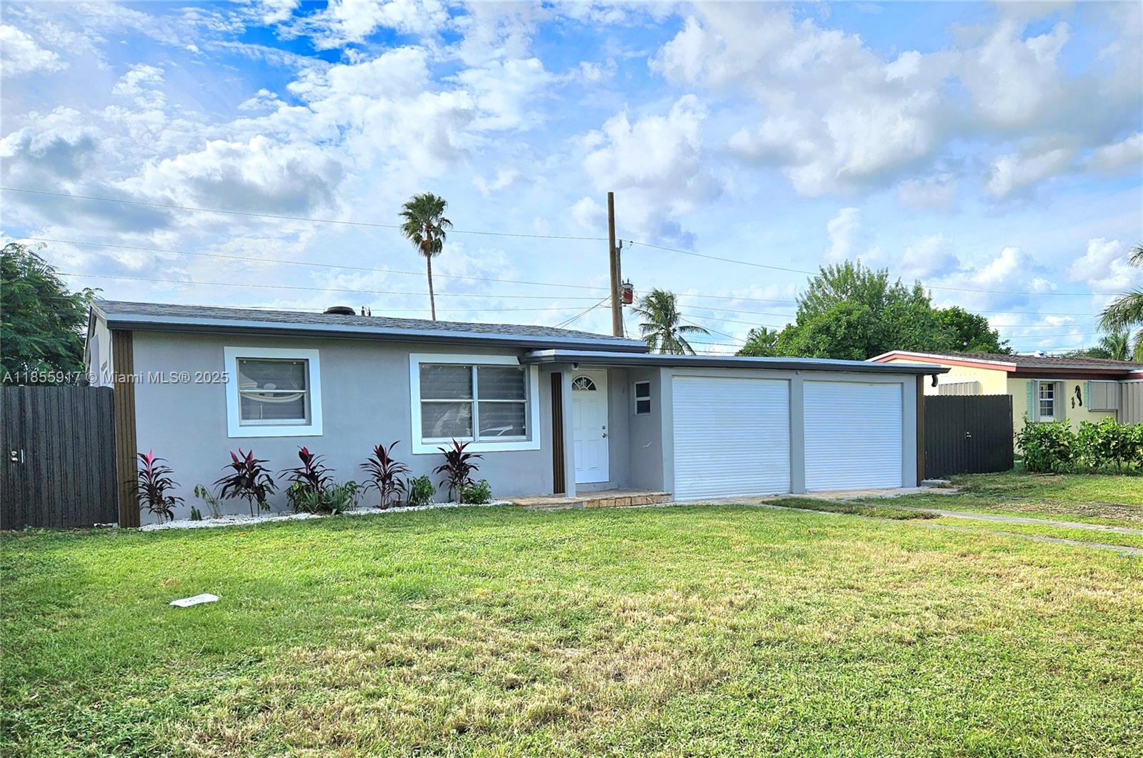 2865 Northeast 13th Avenue Pompano Beach, FL 33064 - Photo 2 of 19 a view of a house with yard and a tree