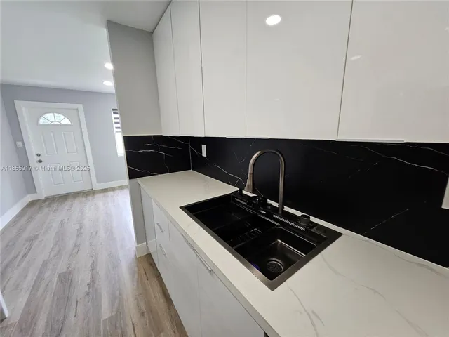 a stove top oven sitting inside of a kitchen