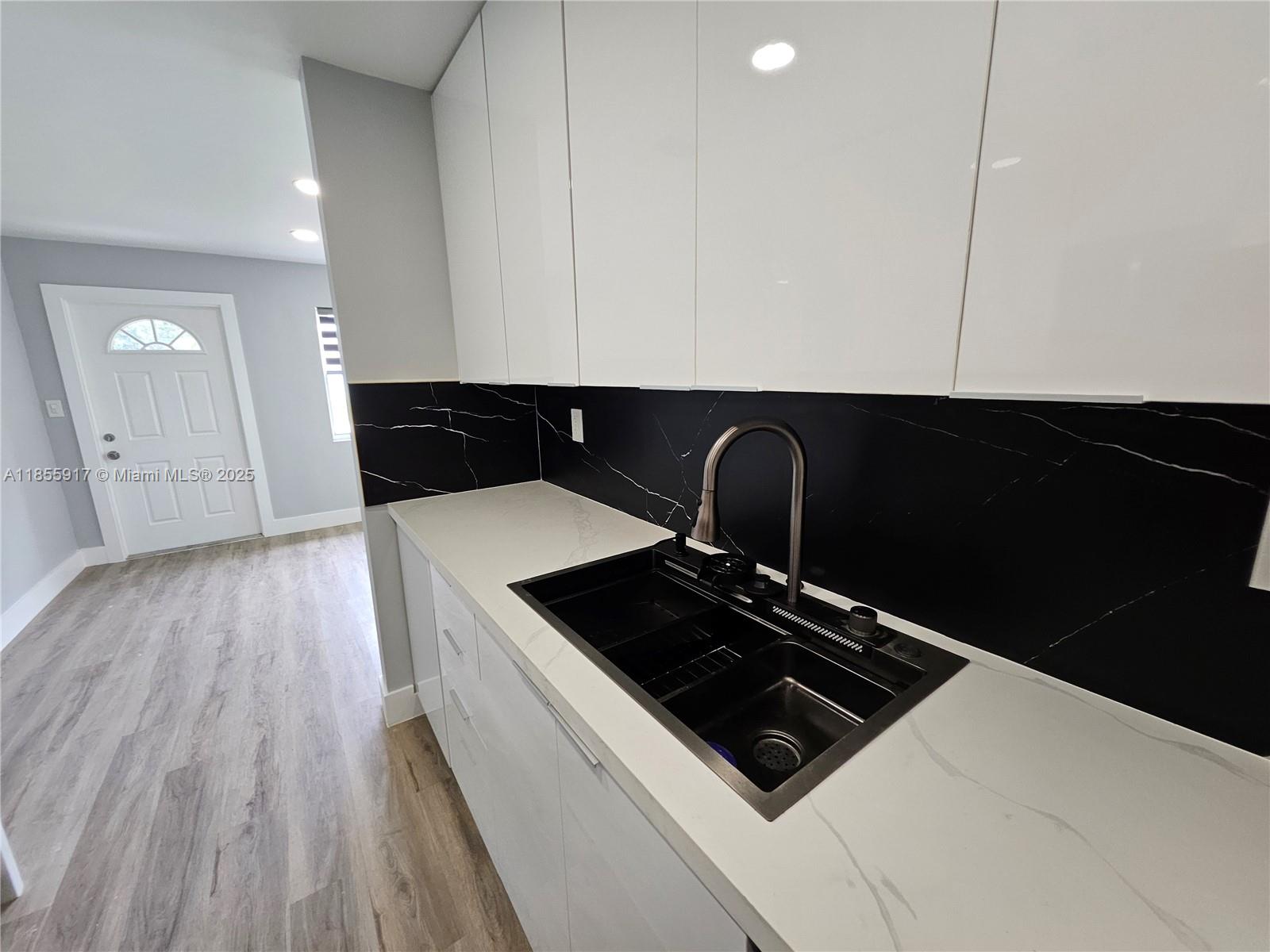 2865 Northeast 13th Avenue Pompano Beach, FL 33064 - Photo 7 of 19 a stove top oven sitting inside of a kitchen