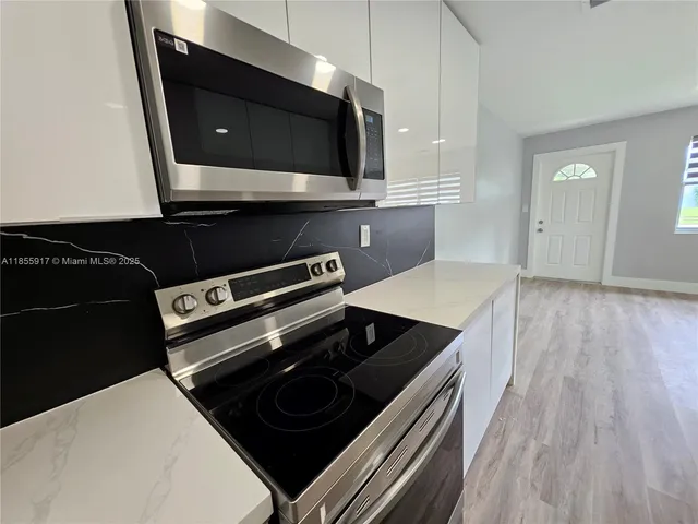 a kitchen with a stove and a microwave