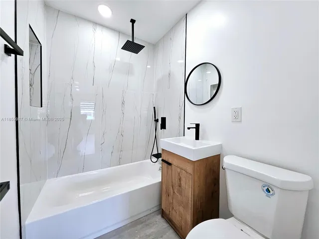 a bathroom with a sink toilet and a bathtub