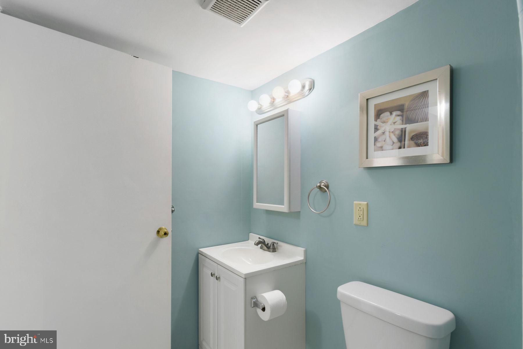 11 62nd Street, Unit 205 Ocean City, MD 21842 - Photo 12 of 18 a bathroom with a toilet sink and mirror
