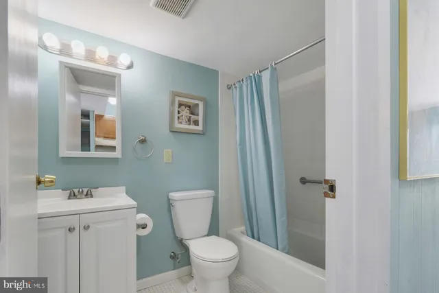 a white toilet sitting next to a bathroom sink