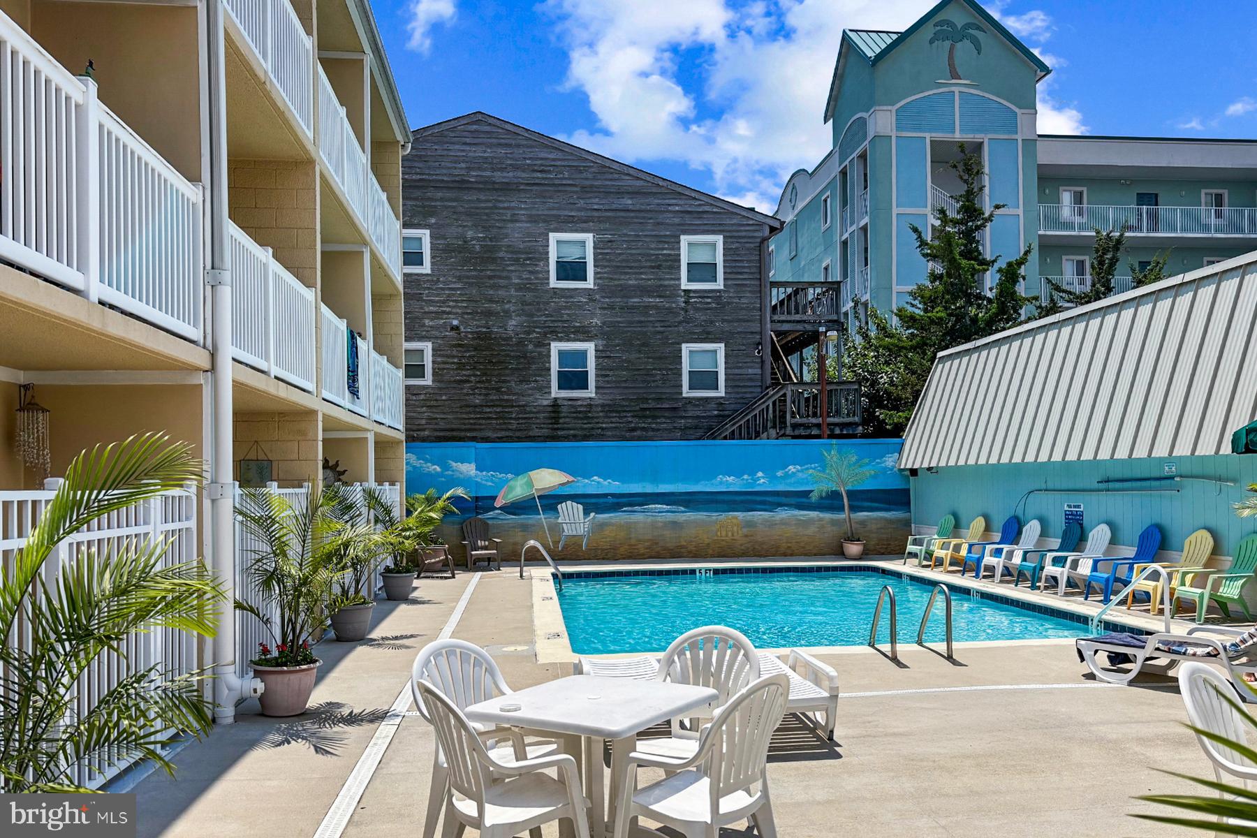 11 62nd Street, Unit 205 Ocean City, MD 21842 - Photo 15 of 18 a view of a patio with couches table and chairs and potted plants