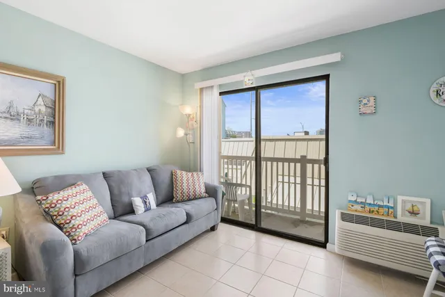 a bedroom with a bed couch and window