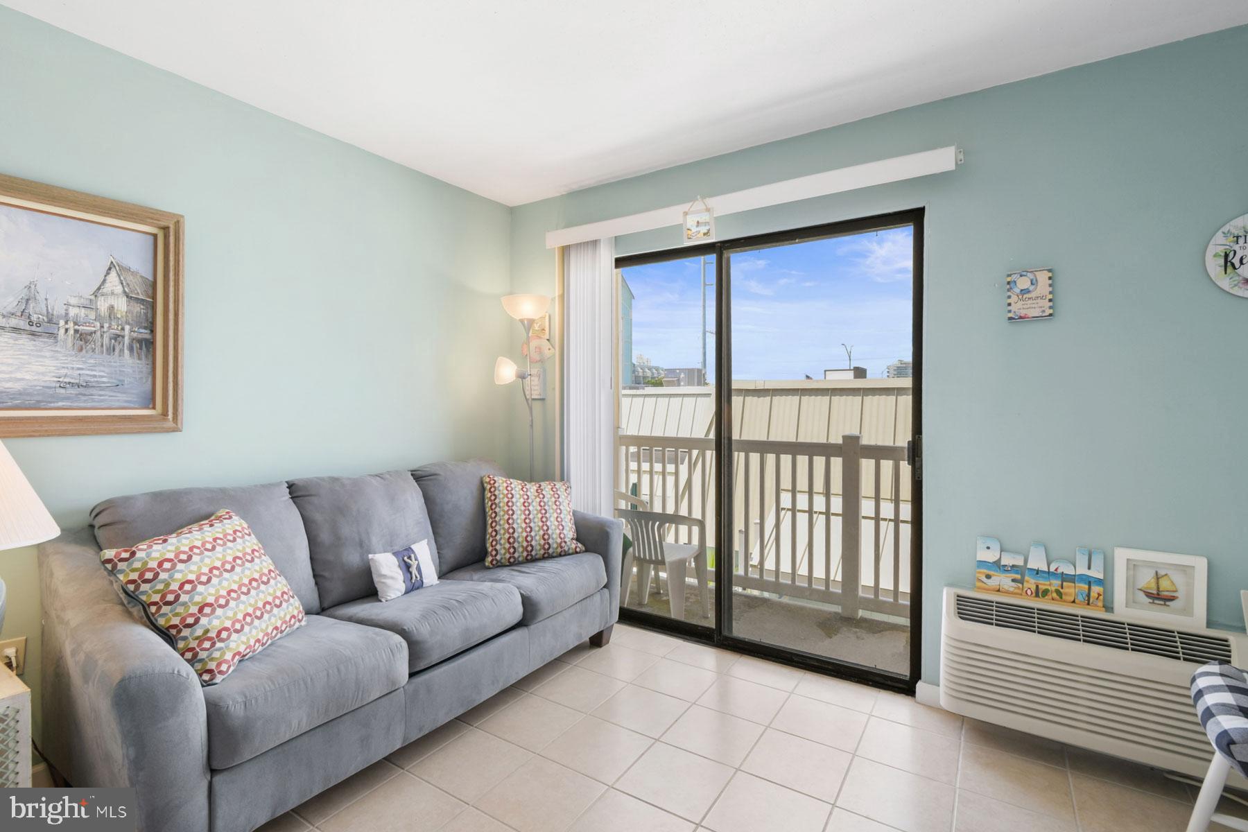 11 62nd Street, Unit 205 Ocean City, MD 21842 - Photo 7 of 18 a living room with furniture and a window