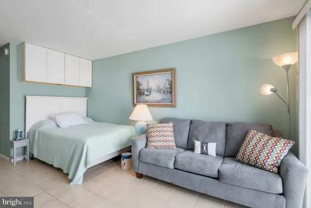 a bedroom with a bed and a painting on the wall