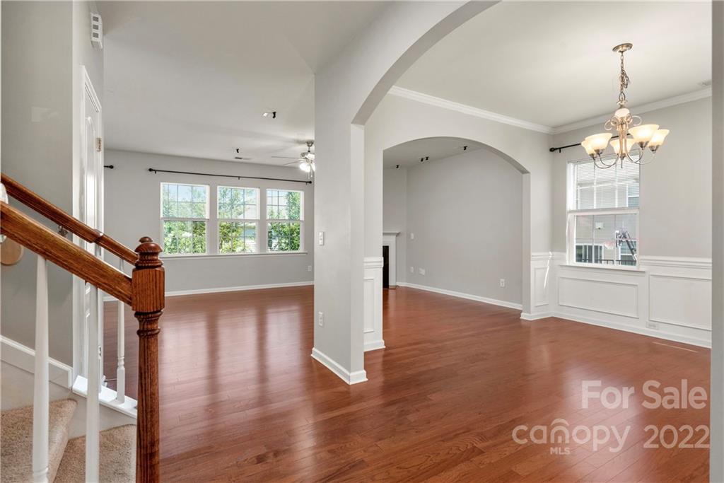 2831 Turquoise Circle Davidson, NC 28036 - Photo 17 of 44 a view of a hallway with wooden floor and a kitchen