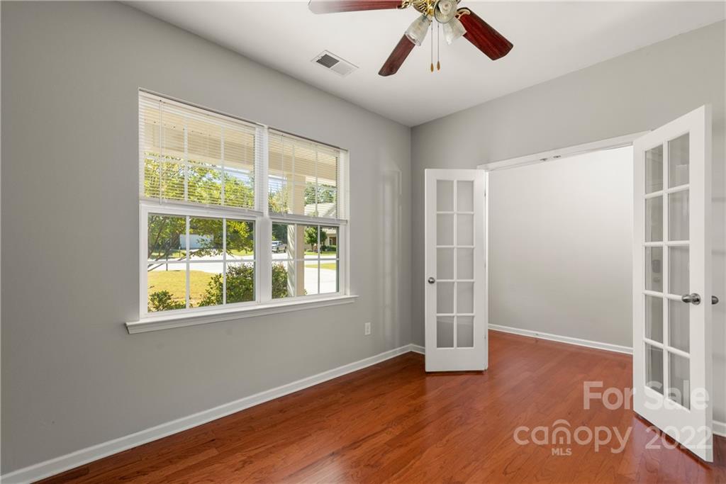 2831 Turquoise Circle Davidson, NC 28036 - Photo 18 of 44 a view of an empty room with a window and wooden floor