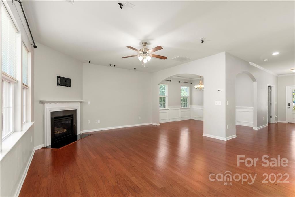 2831 Turquoise Circle Davidson, NC 28036 - Photo 5 of 44 a view of an empty room with chandelier fan and wooden floor
