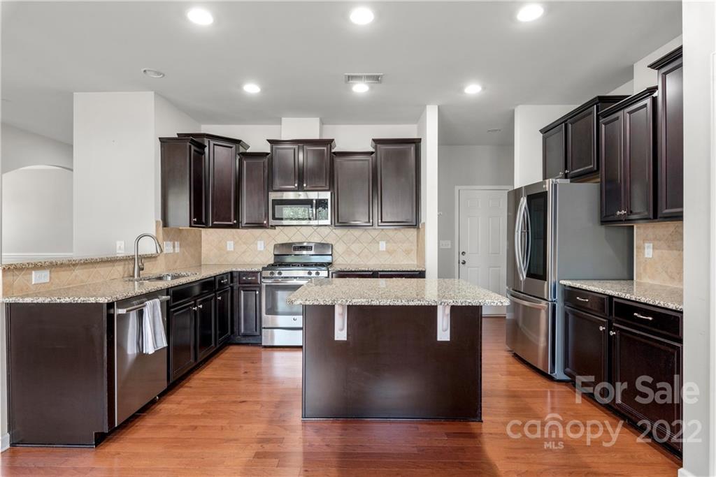 2831 Turquoise Circle Davidson, NC 28036 - Photo 10 of 44 a large kitchen with stainless steel appliances and view kitchen island