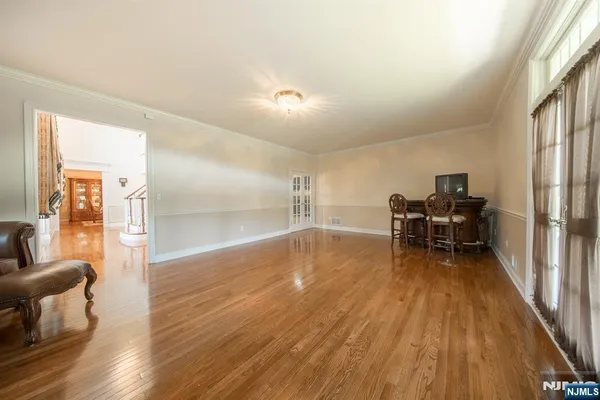 a view of a workspace with furniture and wooden floor