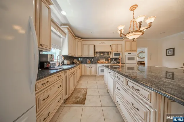 a large kitchen with granite countertop lots of counter top space