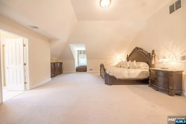 a spacious bedroom with a bed and a window