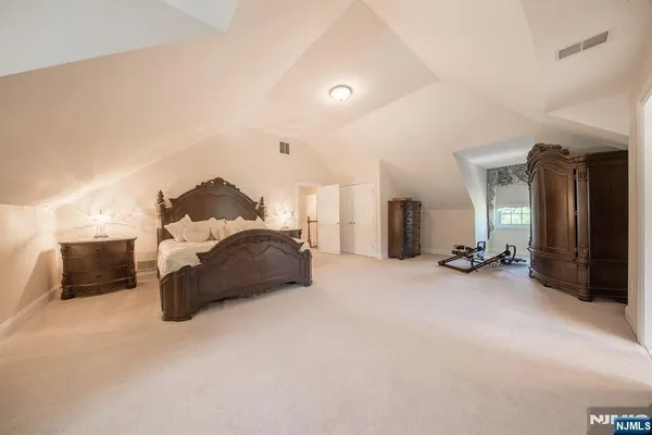 a bed room with furniture and a flat tv screen