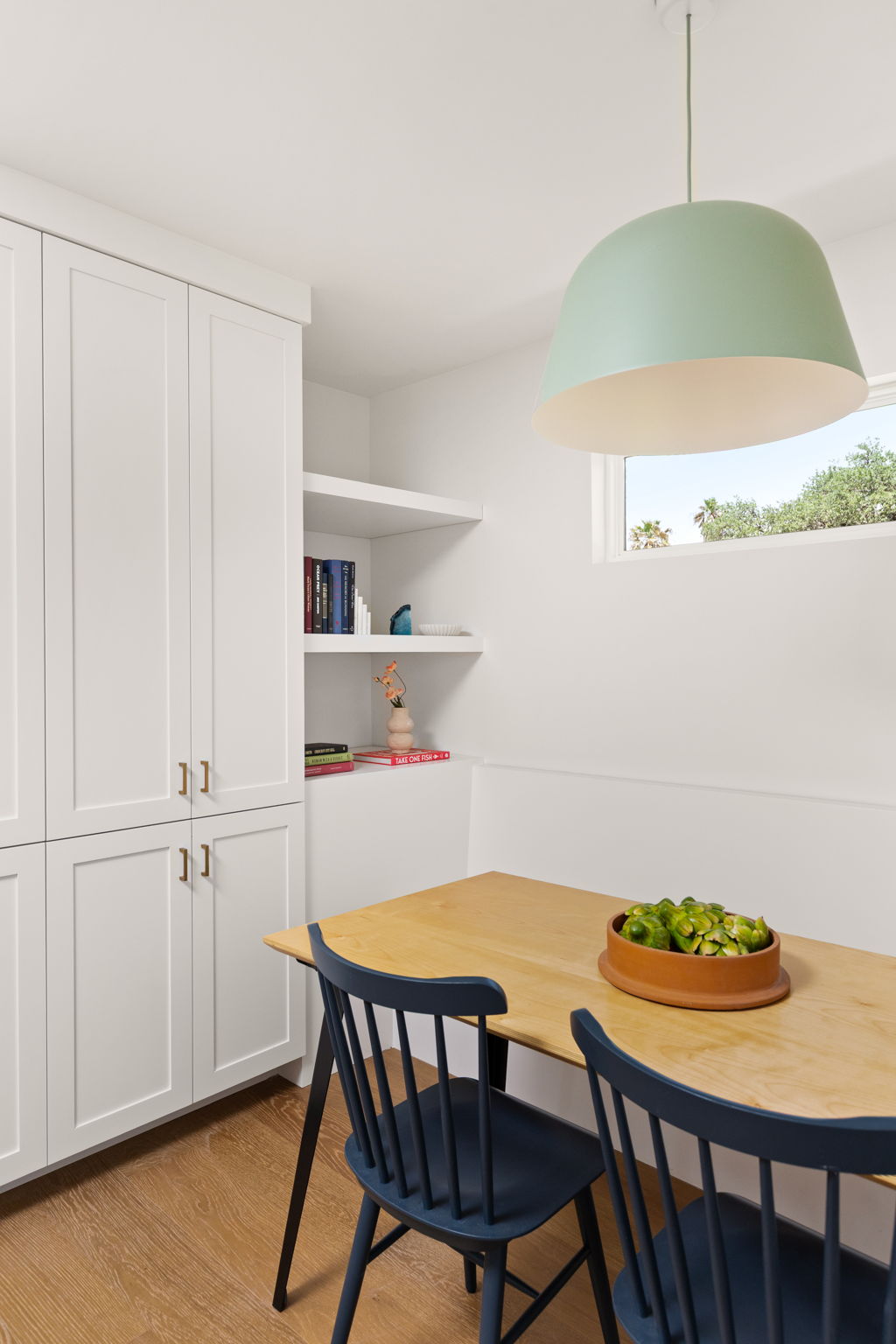 4501 Pack Saddle Pass Austin, TX 78745 - Photo 16 of 37 Recessed dining nook featuring built-in cabinetry, integrated shelving, and a prominent pendant light fixture