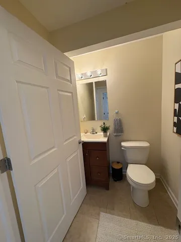a bathroom with a sink a toilet a mirror and vanity