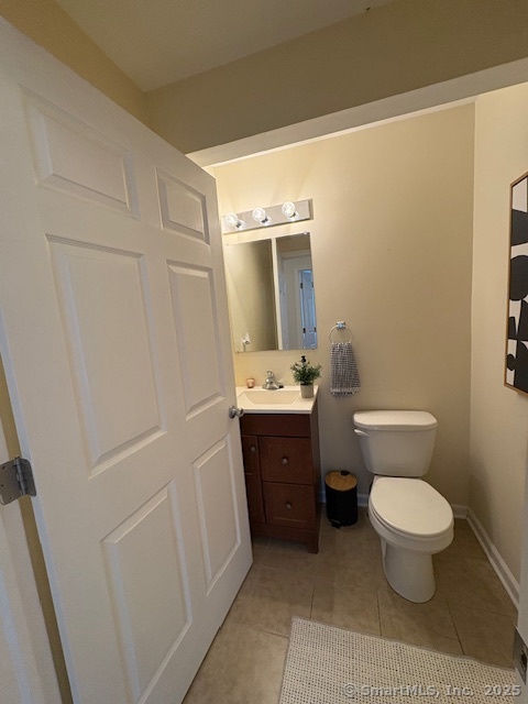 130 Meridian Street, Unit 311 Groton, CT 06340 - Photo 15 of 18 a bathroom with a sink a toilet a mirror and vanity