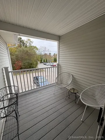 a view of a balcony with chairs