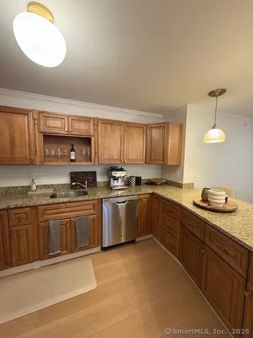 a kitchen with stainless steel appliances granite countertop a sink and cabinets