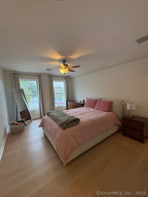 130 Meridian Street, Unit 311 Groton, CT 06340 - Photo 9 of 18 a bedroom with a bed and a chandelier