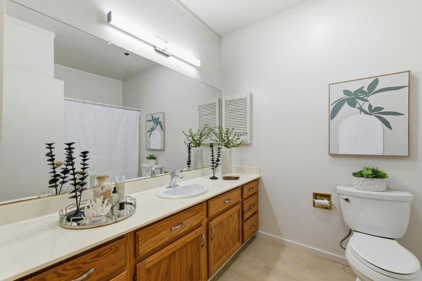 22330 Homestead Road, Unit 226 Cupertino, CA 95014 - Photo 26 of 38 a bathroom with a double vanity sink toilet and a mirror