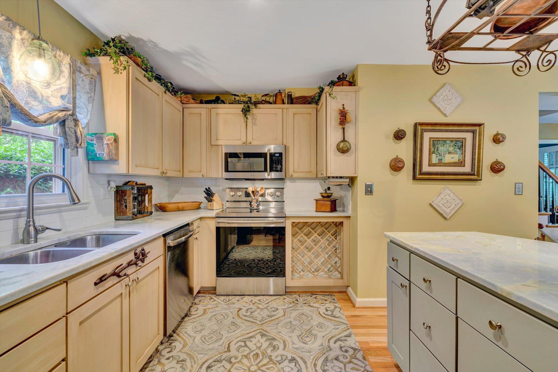 5057 Falcon Ridge Road Roanoke, VA 24018 - Photo 13 of 43 a kitchen with stainless steel appliances a stove sink and cabinets