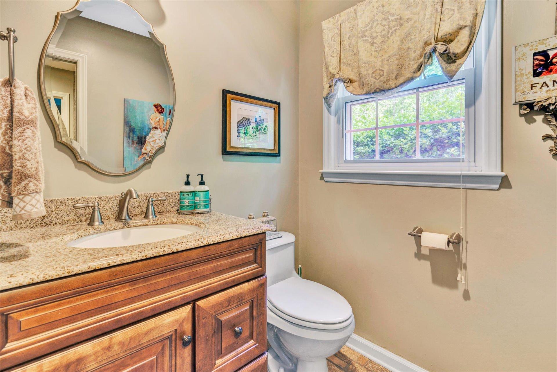 5057 Falcon Ridge Road Roanoke, VA 24018 - Photo 22 of 43 a bathroom with a granite countertop sink mirror and toilet