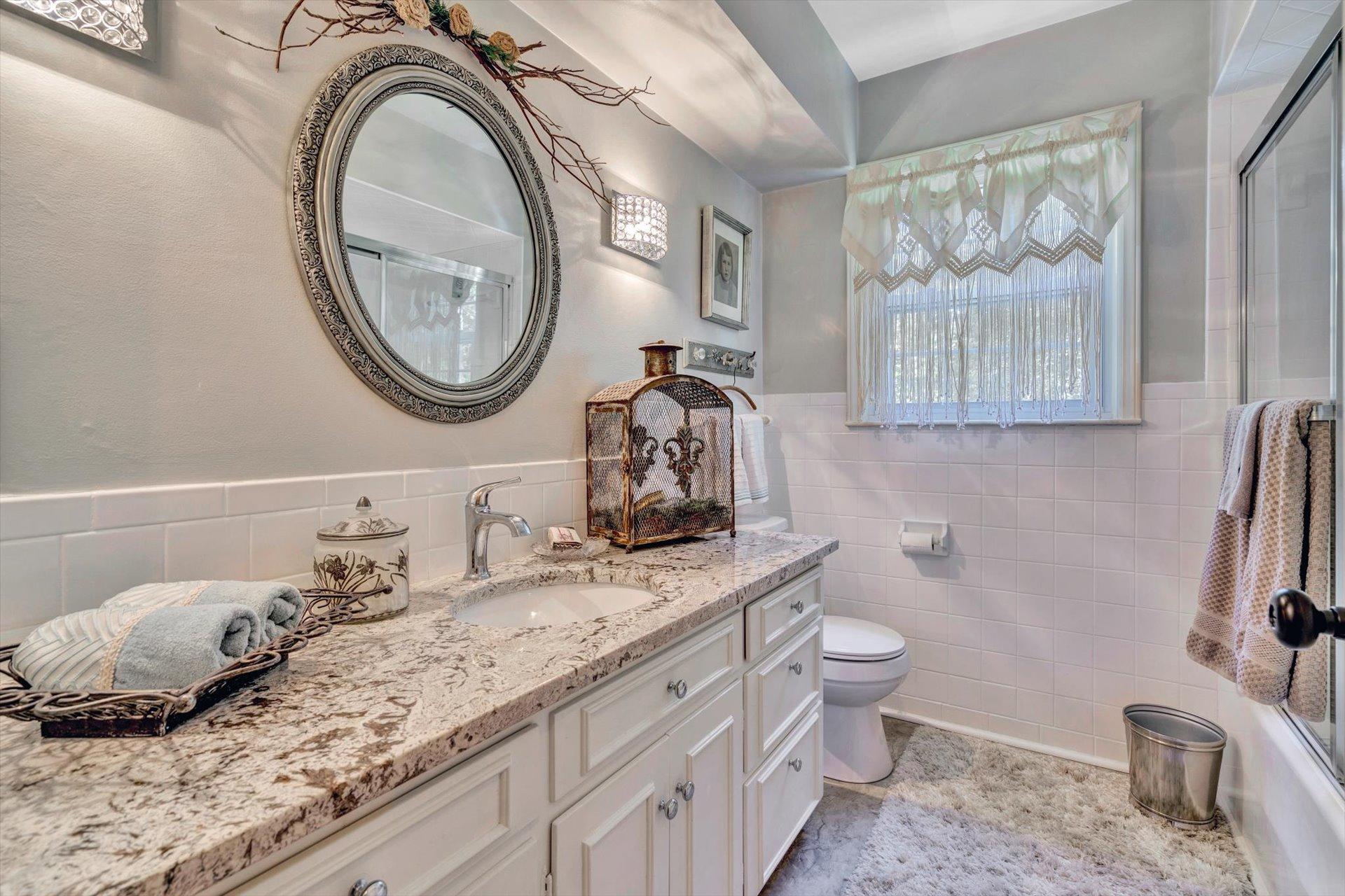 5057 Falcon Ridge Road Roanoke, VA 24018 - Photo 25 of 43 a bathroom with a granite countertop toilet sink and mirror
