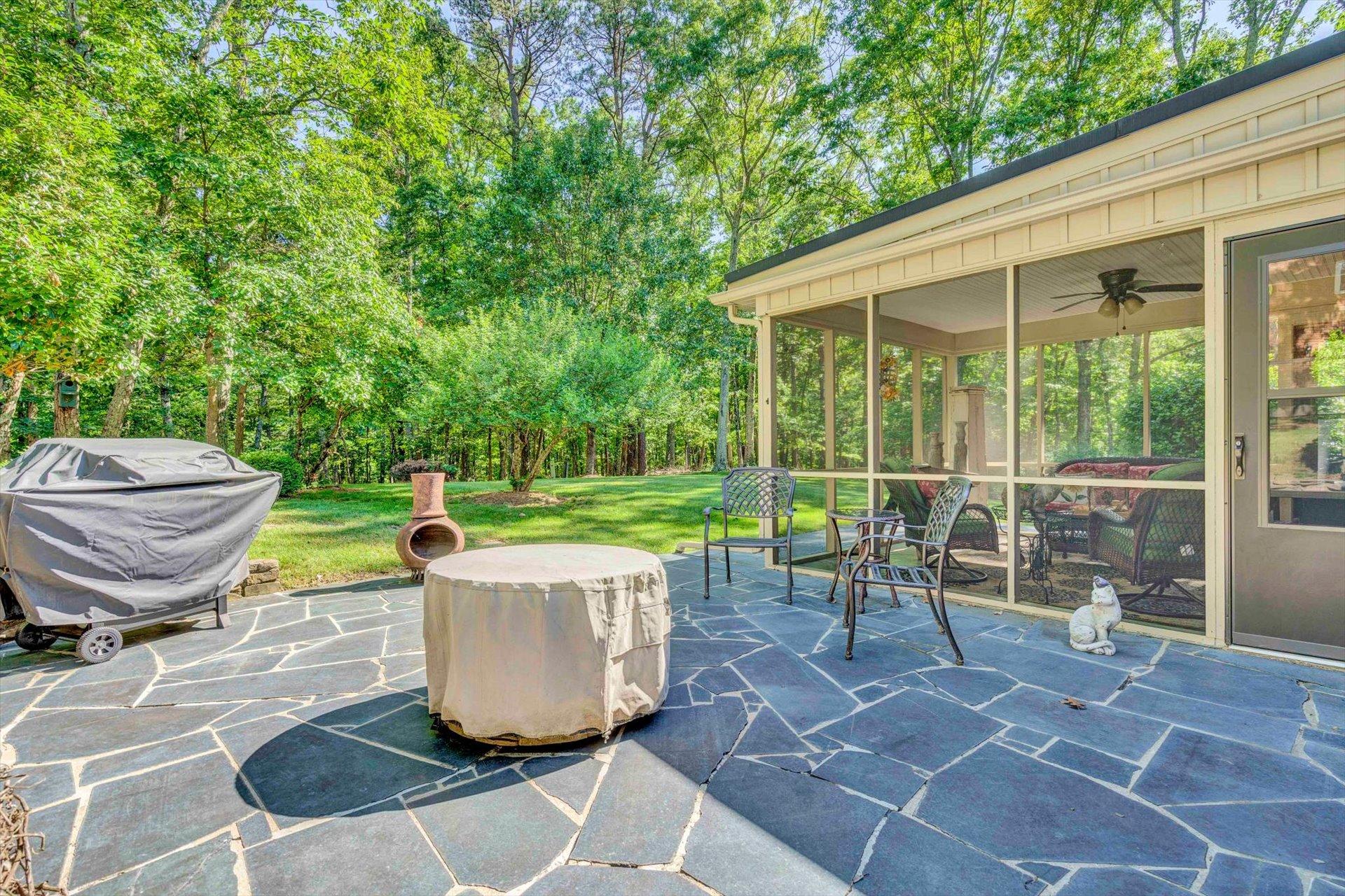 5057 Falcon Ridge Road Roanoke, VA 24018 - Photo 41 of 43 a view of a backyard with table and chairs and a barbeque
