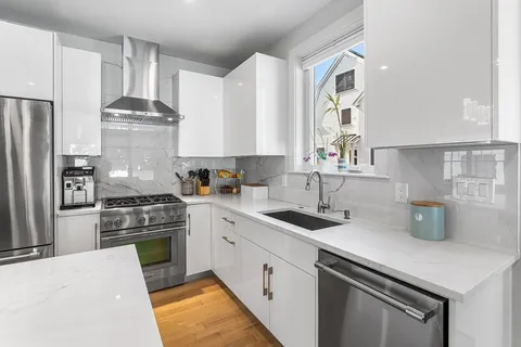 a kitchen with a sink stove and refrigerator