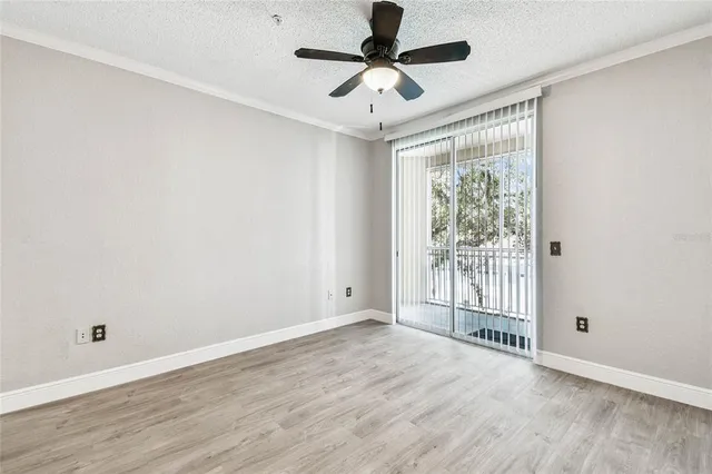 a view of a livingroom with wooden floor and a ceiling fan