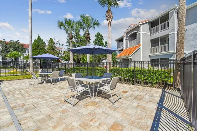 a view of a house with backyard sitting area and garden