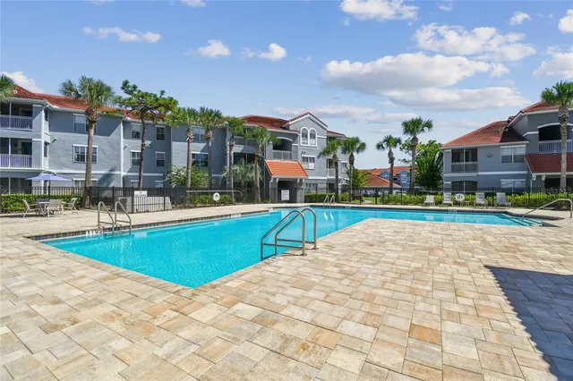a view of swimming pool in front of residential houses