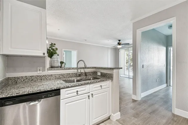 a kitchen with stainless steel appliances granite countertop a sink and cabinets