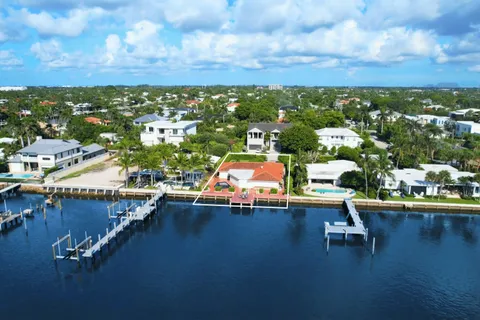 an aerial view of a swimming pool with outdoor seating