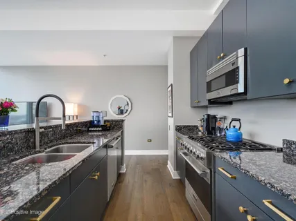 a kitchen with stainless steel appliances granite countertop a stove and a microwave
