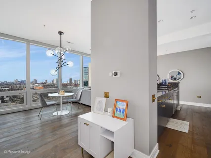 a kitchen with stainless steel appliances granite countertop a dining table and chairs