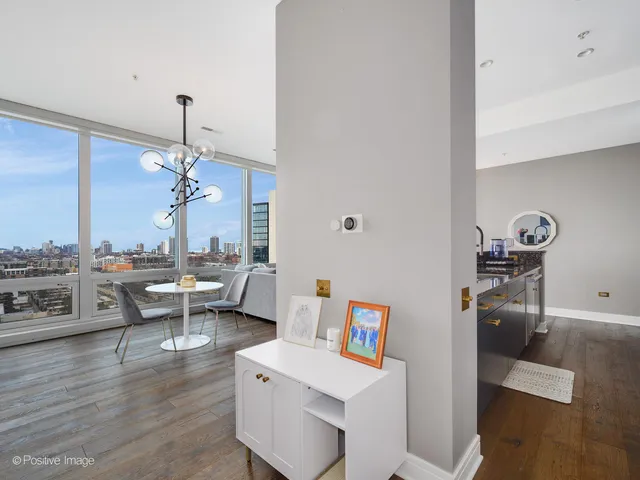 a kitchen with stainless steel appliances granite countertop a dining table and chairs