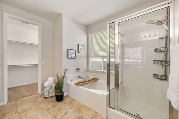 a bathroom with a bathtub and a shower