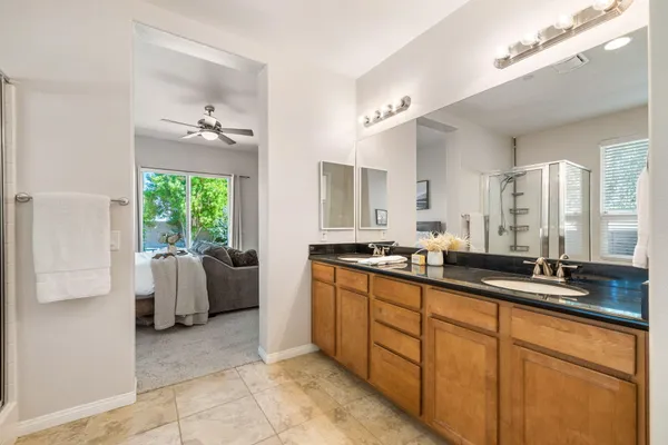 a large bathroom with a double vanity sink large mirror and tub
