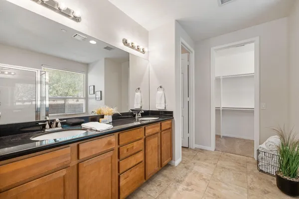 a bathroom with double sink and a mirror